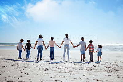 Buy stock photo Support, back and big family holding hands at the beach, summer walking and travel holiday in nature of Portugal. Hope, love and women with affection for adopted kids on a vacation at the ocean