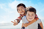 Beach, peace sign and Asian children hug on Japan travel vacation for calm, freedom and outdoor nature. Blue sky, ocean sea or happy youth portrait of fun kids or friends on holiday playing piggyback