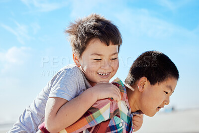 Buy stock photo Asian kids, siblings and piggyback on the beach for fun summer vacation together in the outdoors. Happy Japanese children with smile playing by the ocean coast on a back ride on a warm sunny day