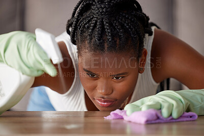 Buy stock photo Cleaning, dust and black woman with spray on a table for furniture care, home hygiene and housework. Housekeeping service, check and African cleaner wiping dirt from a counter with detergent