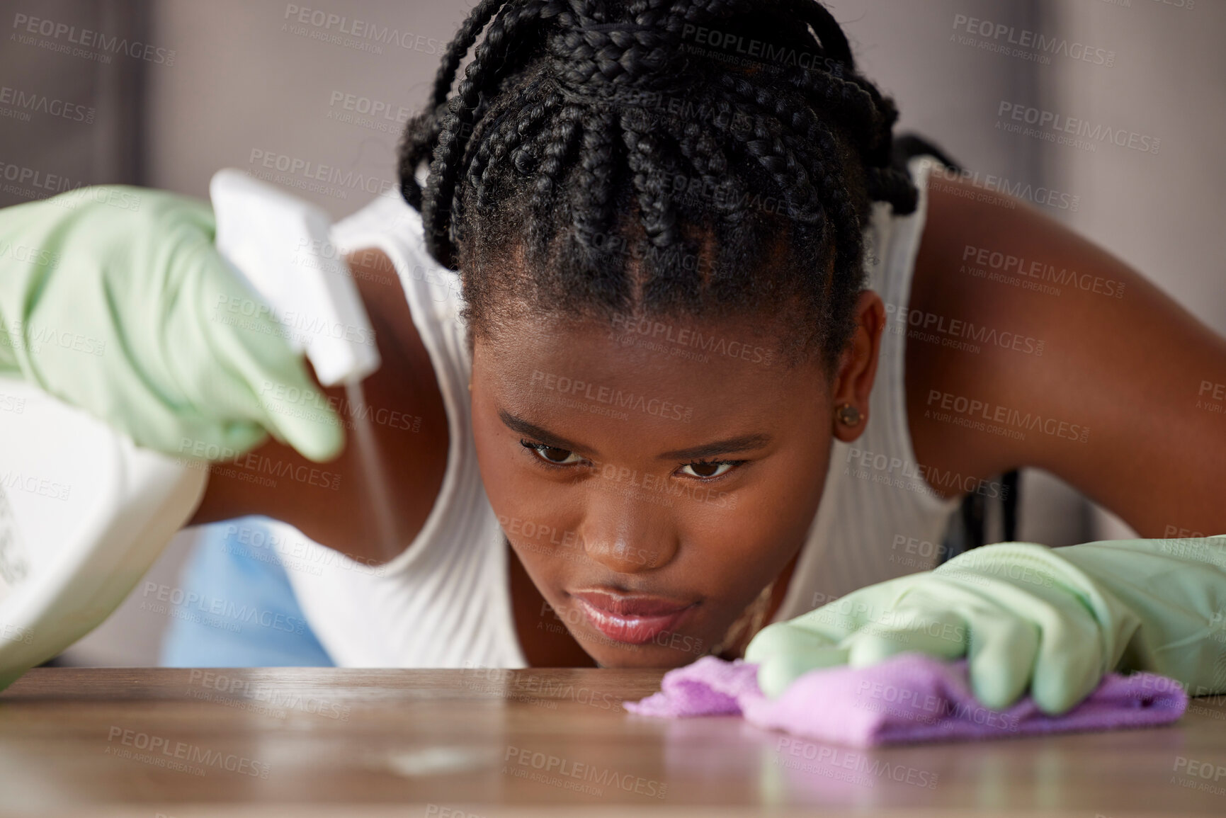 Buy stock photo Cleaning, dust and black woman with spray on a table for furniture care, home hygiene and housework. Housekeeping service, check and African cleaner wiping dirt from a counter with detergent