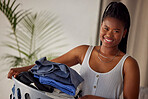 Laundry, basket and portrait of black woman with clothes folded, housekeeping and smile in living room. Happiness, cleaning and washing, happy modern housewife doing household chores in Atlanta home.