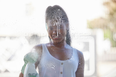 Buy stock photo House work, window cleaning and black woman with bottle to spray soap while spring cleaning windows with gloves. Housework, dirt and woman happy working to clean dust on glass in New York apartment.