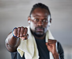 Fist, boxer and martial arts with black man and fitness, sports and boxing with exercise and hand zoom. Athlete, wellness and MMA fighter with towel, workout and training with sports motivation