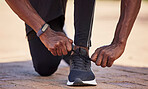 Workout shoes, running and black man runner with fitness outdoor, hands and start run, healthy lifestyle and athlete with sport. Exercise, sneakers and body training with sports motivation and cardio