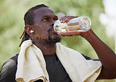 Buy stock photo Water, fitness break and black man running in nature, exercise hydration and focus on body performance in Germany. Thirsty, training and African runner thinking of cardio workout in park with a drink