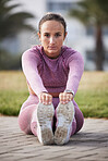 Woman, exercise and fitness portrait while stretching outdoor at a city park for health and wellness. Athlete female sitting for warm up, cardio workout and running for healthy lifestyle and body