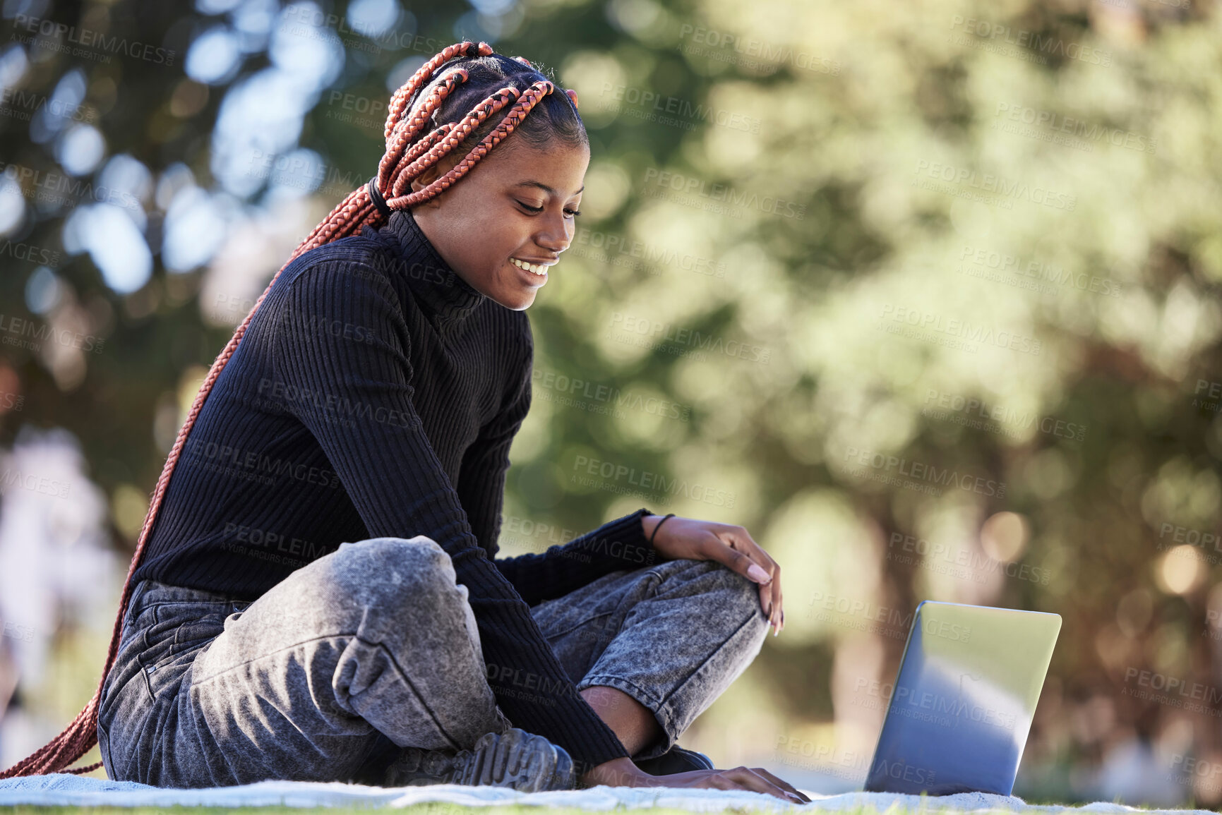 Buy stock photo Black woman, laptop and relax outdoor picnic for college studying, happy learning and digital education. Nature park, young African girl smile and reading university communication online in sunshine