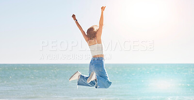 Buy stock photo Happy woman, freedom and jump at beach with arms stretching for purpose, energy and motivation. Back view, success and fun at sea, summer vacation and sunshine travel, hope and wellness celebration 