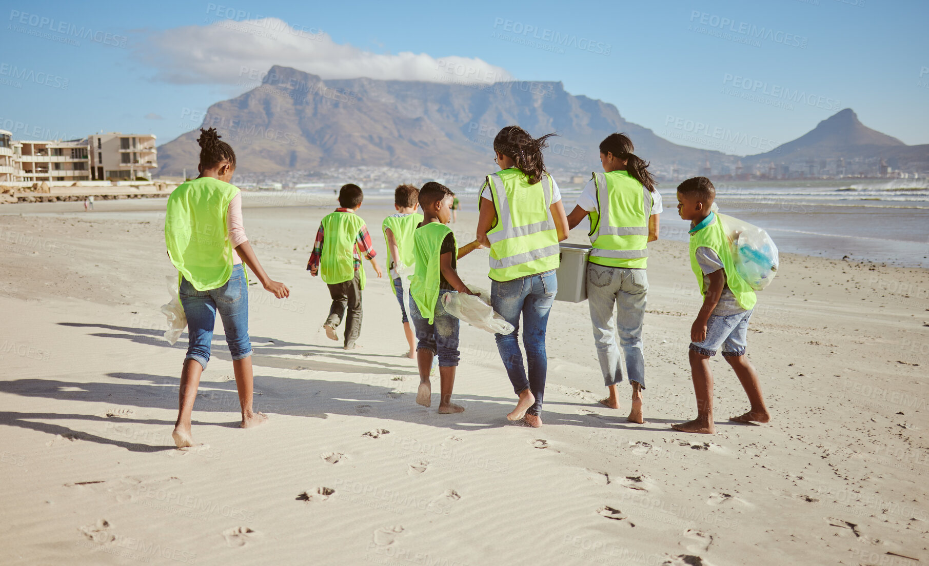 Buy stock photo Woman, children and beach clean up in school accountability learning, climate change collection or sustainability recycling. Kids, students diversity and people in community service or ocean cleaning
