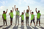 Children, volunteer and beach clean up with friends standing on the sand together for eco friendly conservation. Team, nature and cleaning with kids cleaning the environment for a green earth