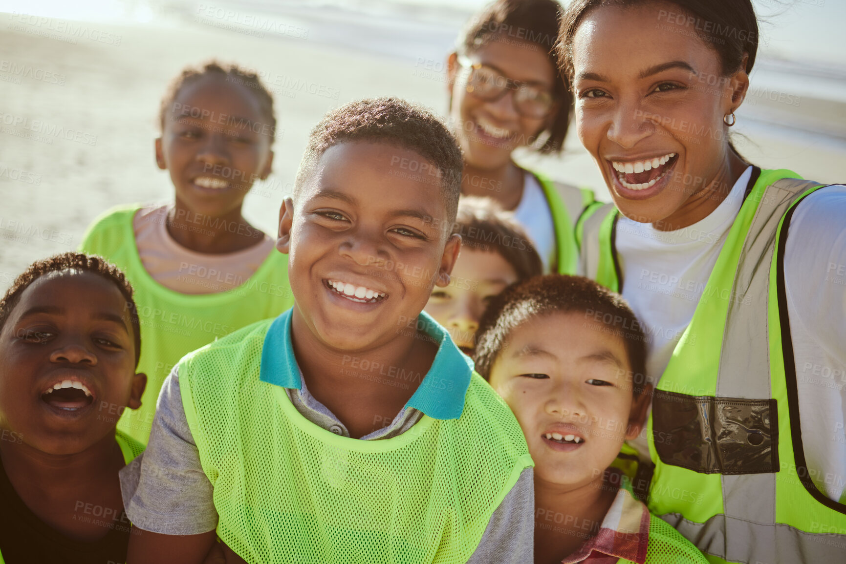 Buy stock photo Children, portrait and volunteer with an eco friendly beach cleaning for earth day or environmental sustainability. Charity, kids or face with a group of friends in nature for community service