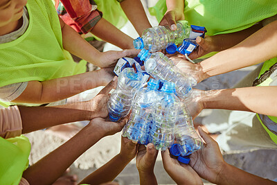 Buy stock photo Children, hands and plastic bottles in beach waste management, community service or climate change volunteer. Kids diversity, teamwork and trash cleaning, environment sustainability or nature recycle