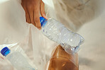 Cleaning, plastic and hands of volunteer at beach for recycle, environment or earth day. Recycling, sustainability and  climate change with charity activist and bottles for pollution and eco friendly