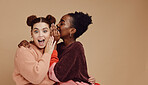 Friends, gossip and women share secret on studio background and product placement mockup. Secrets, rumours and surprise whisper in ear, black woman with happy woman discuss discount sale announcement