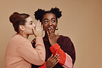 Friends, gossip and women share secret on studio background and product placement mockup. Secrets, rumours and surprise whisper in ear, black woman with happy woman discuss discount sale announcement