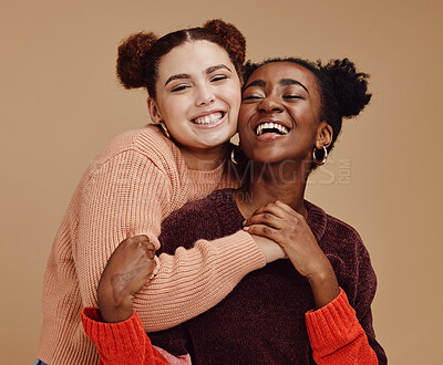 Buy stock photo Lesbian, couple hug with young women and happy with fashion and marketing, love and fun together against studio background. Lgbtq community, gen z and freedom with style and lgbt people with pride