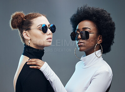 Buy stock photo Fashion, friends and women with sunglasses in studio for cosmetics, makeup and futuristic style. Luxury models, designer brand and confident girls with stylish accessory, trendy clothes and jewellery