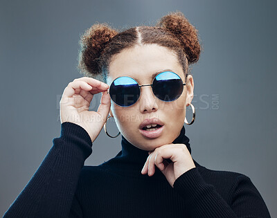 Buy stock photo Face, sunglasses and fashion with young woman, style and designer with trendy brand and gen z against studio background. Style, edgy and young girl, marketing with fashion model and stylish beauty