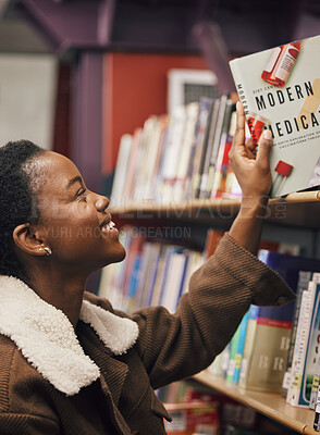 Buy stock photo Black woman, student and book in library for medical exam, pills and healthcare education, learning about pharmaceutical drugs. Reading information, learn and study, medicine research with pharmacy