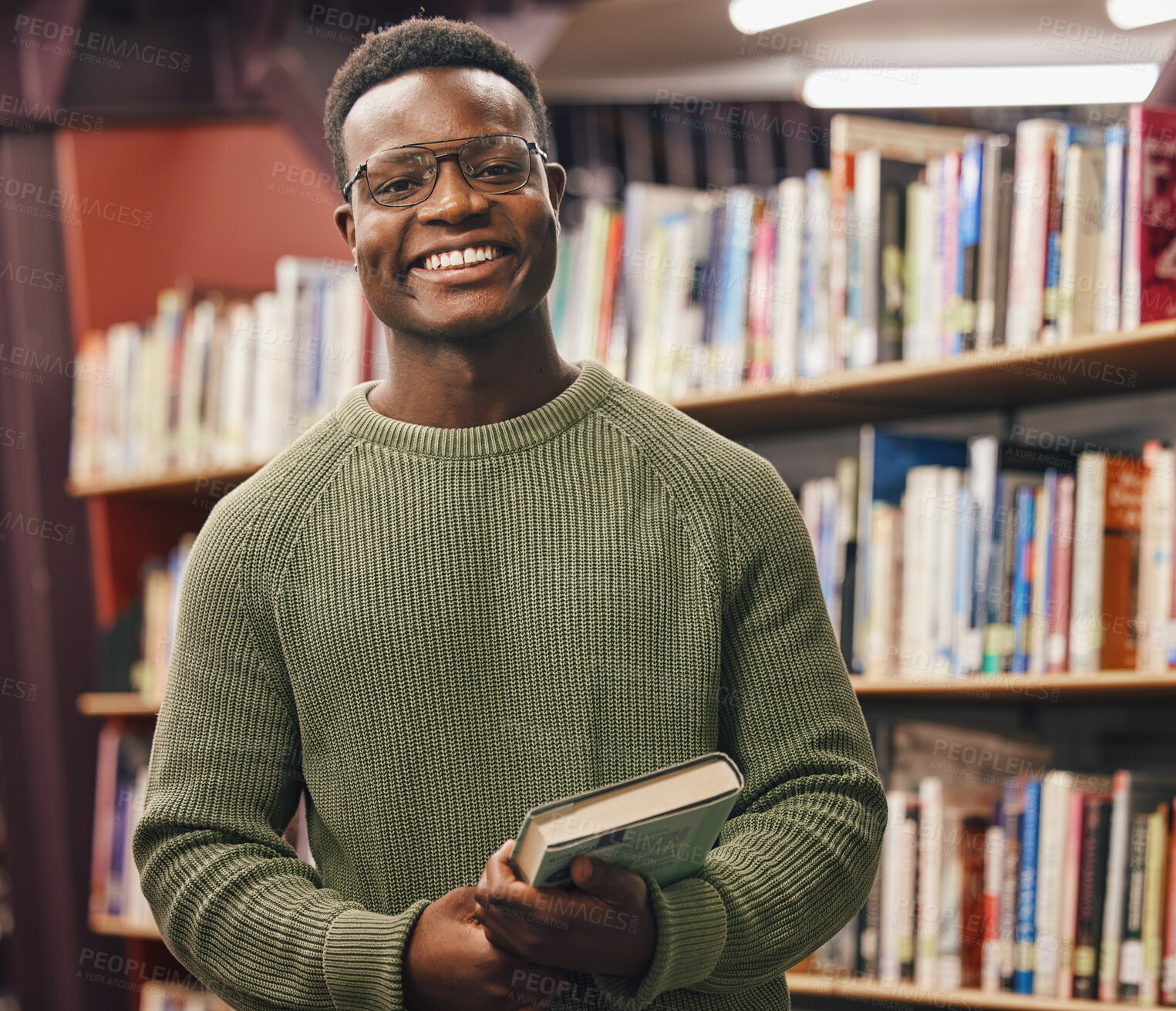Buy stock photo Black man, student and portrait in library for book, research and education at college with smile. African gen z learner, books and shelf at university for goals, learning and motivation for future