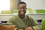 Black man, student and portrait in classroom for education, study and happy at college with smile. African gen z learner, class and desk at university for goals, learning and motivation for future