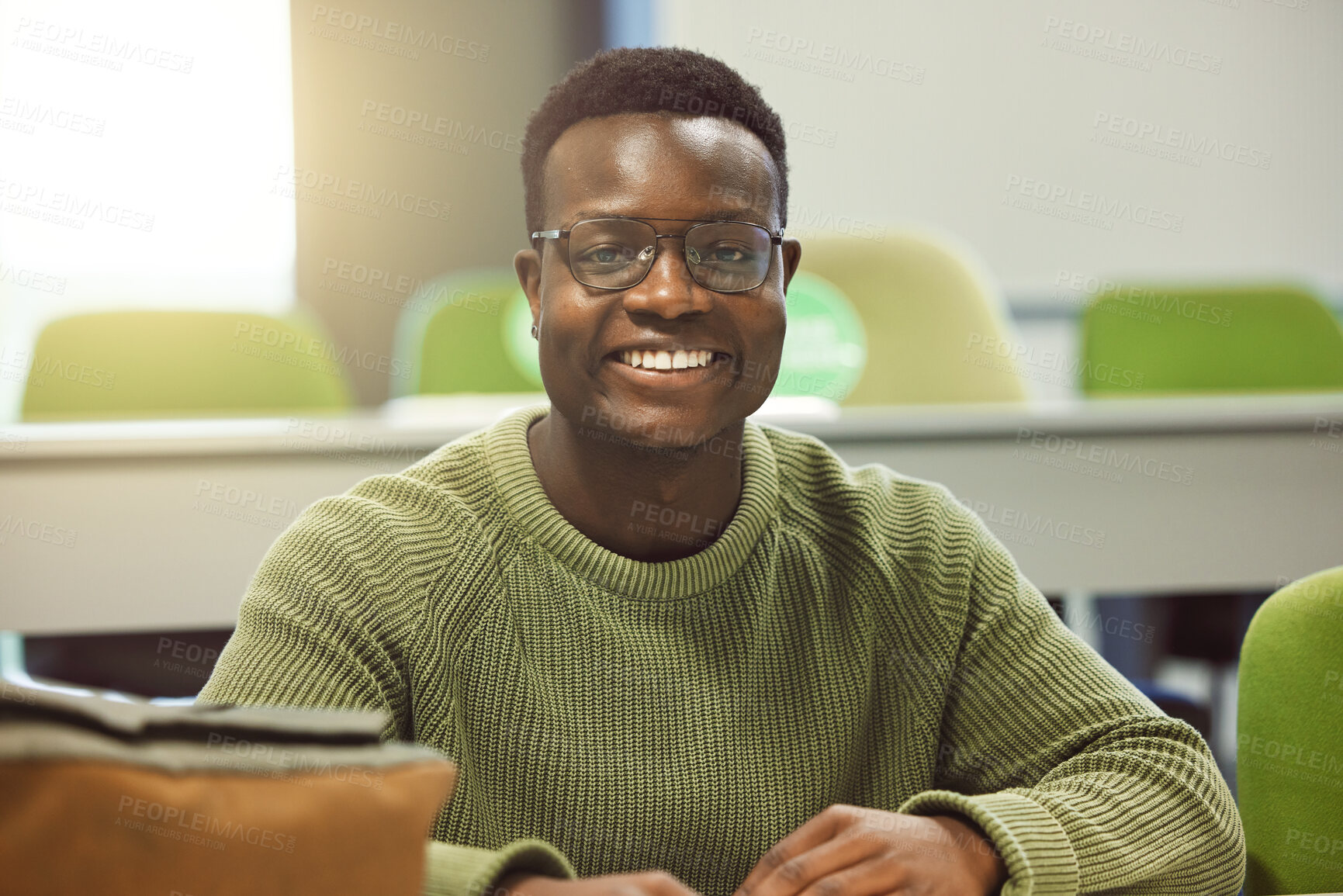 Buy stock photo Black man, student and portrait in classroom for education, study and happy at college with smile. African gen z learner, class and desk at university for goals, learning and motivation for future