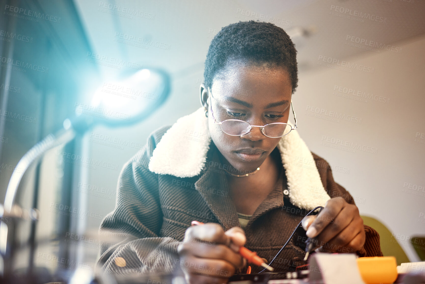 Buy stock photo Black woman, student and engineer with electrical project while learning and studying. Education, engineering or technician at college with technology voltage meter for electricity and innovation