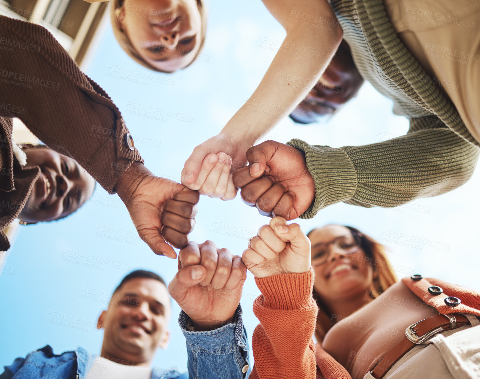Buy stock photo Group of friends, hands bump in huddle and group diversity, team building circle from below. Friendship, happiness and university students in fist bump, men and women smile together on college campus