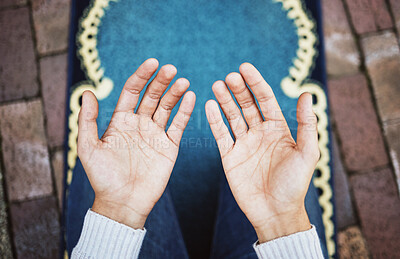 Buy stock photo Hands, muslim and praying in worship to Allah, god or creator on salah mat making dua on the floor. Hand of islamic man in pray for islam religion, spiritual or respect for belief or culture outside
