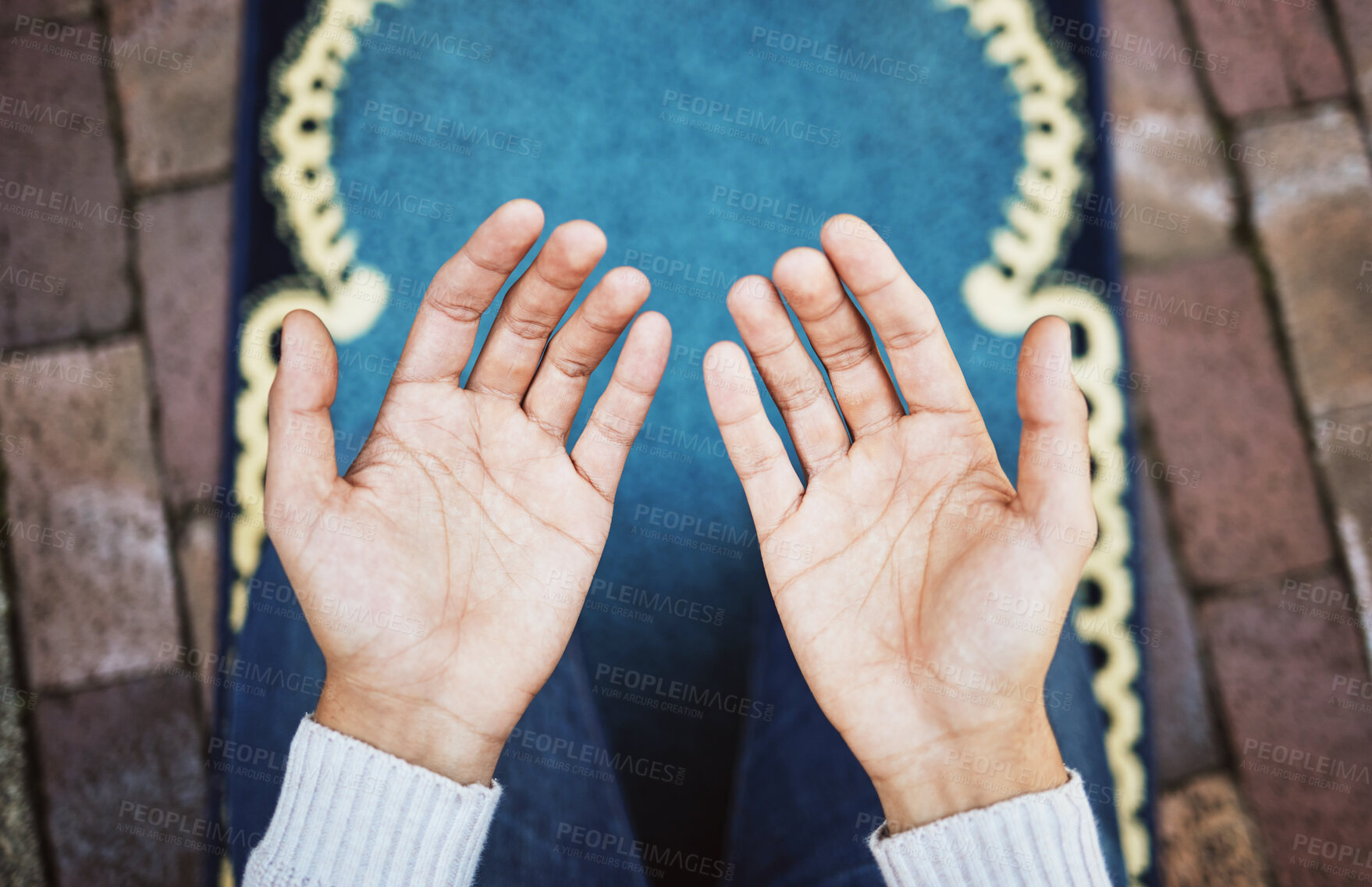 Buy stock photo Hands, muslim and praying in worship to Allah, god or creator on salah mat making dua on the floor. Hand of islamic man in pray for islam religion, spiritual or respect for belief or culture outside