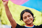 Rainbow, flag and gay pride with an indian woman in a city in celebration of lgbt equality or freedom. Community, support or human rights with a gender neutral or non binary female celebrating lgbtq