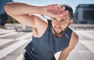 Buy stock photo Fitness, man and relaxing on break from workout, training or exercise in the city for healthy recovery in the outdoors. Sporty male breathing feeling tired, exhausted or drained after running cardio
