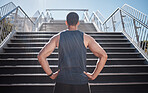 Fitness, man and sport determination in city for running, exercise or healthy cardio by staircase. Muscular sporty male ready for training, workout or sports run by stairs for wellness in town