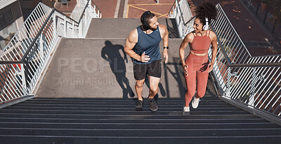 Buy stock photo Fitness, stairs and city with a diversity couple training for sports, cardio or endurance outdoor together. Workout, health and exercise with a man and woman athlete running up a staircase from above