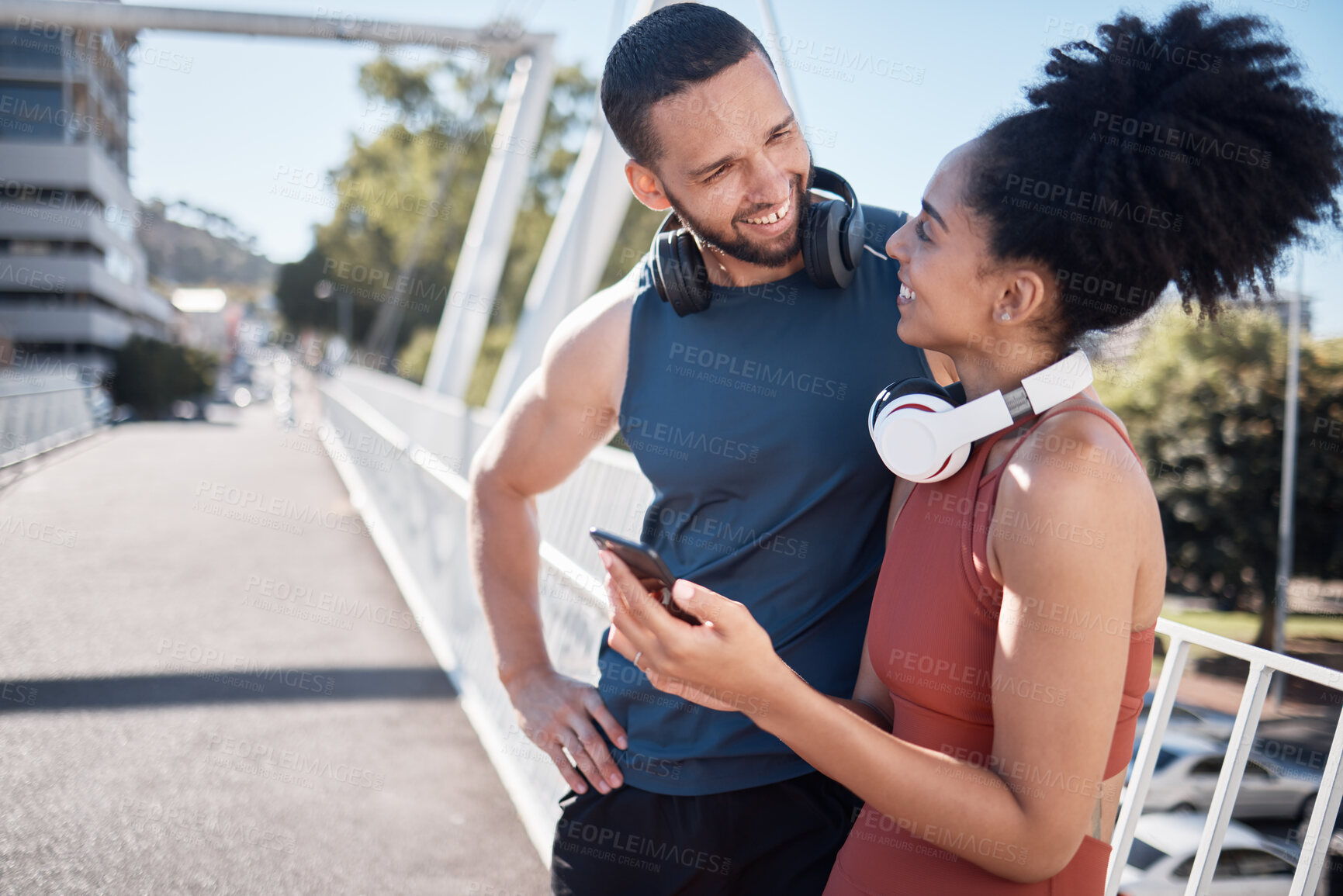 Buy stock photo Fitness, exercise and black couple with phone in city for running, marathon training and workout on bridge. Love, sports and man and woman on smartphone for social media, music and health mobile app