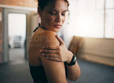 Buy stock photo Woman, fitness and shoulder injury from sports workout, exercise or training at the gym indoors. Female holding arm after painful sport accident, inflammation or bruise from intense exercising