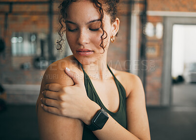 Buy stock photo Woman, shoulder pain and muscle injury from sports workout, exercise or training at the gym indoors. Female holding arm after painful sport accident, inflammation or bruise from intense exercising