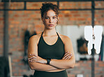 Fitness portrait, exercise and serious woman at gym for a workout, training and body motivation at health club. Face of sports or athlete female focus on performance, progress and healthy lifestyle