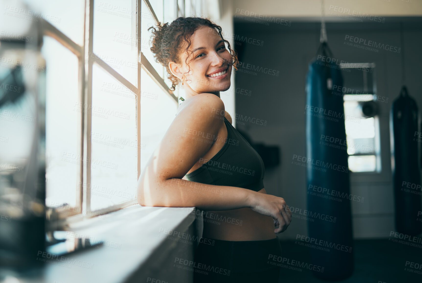 Buy stock photo Portrait, window and woman with smile, fitness and workout for wellness, healthy lifestyle or exercise. Happy female, lady or athlete in gym training, sunshine or practice for cardio, energy or power