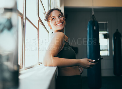 Buy stock photo Window, smartphone and woman in gym, smile and online for training schedule, motivation and achievement. Happy, female athlete and girl with cellphone, break and connection for website and wellness