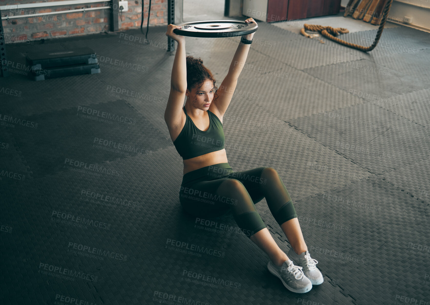 Buy stock photo Exercise, weight plate and woman at gym for workout, fitness and training for health and body wellness. Strong sports female or bodybuilder on floor doing weightlifting for power, energy and balance
