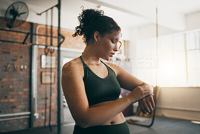 Buy stock photo Fitness, smartwatch and gym workout progess of a woman doing exercise, training and body wellness. Young sports female or athlete with app for time while active to be strong, healthy and for energy