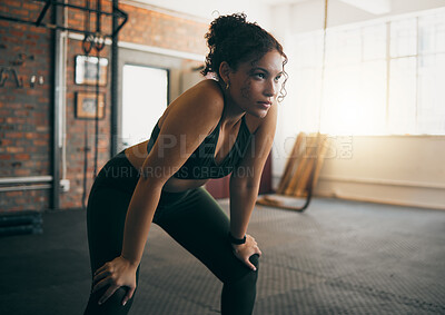 Buy stock photo Fitness, exercise and woman tired at gym after a workout or training for health and body wellness. Young sports female or athlete resting on break while thinking about goals, progress and performance