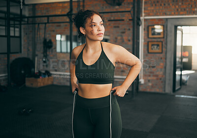 Buy stock photo Exercise, skipping rope and a woman at gym for a fitness workout, cardio training and body wellness or balance. Young sports female or athlete thinking to train to be strong, healthy and for energy
