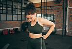 Fitness, exercise and woman at gym to check body progess after training for health, balance and wellness. A young sports female or athlete strong and healthy while on diet and active to lose weight