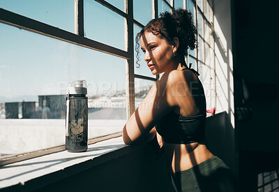 Buy stock photo View, exercise and relax with a sports woman looking out of a window during a break in the gym for fitness. Health, wellness and training with a female athlete taking a break from her studio workout