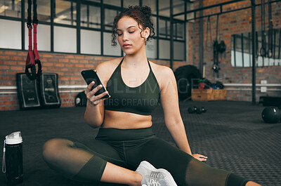 Buy stock photo Woman, fitness and phone at gym for a workout, training and body wellness with a mobile app. Young sports female with smartphone for progress, performance and communication for a healthy lifestyle