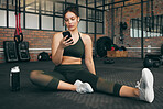 Fitness, phone and woman at gym for a workout, training and body wellness with a mobile app. Young sports female with smartphone for progress, performance and communication for a healthy lifestyle
