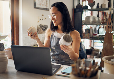 Buy stock photo Asian woman, laptop and pottery business with smile for creative startup holding ceramic creation in the workshop. Happy woman business owner smiling for art, design or clay craft by computer at work